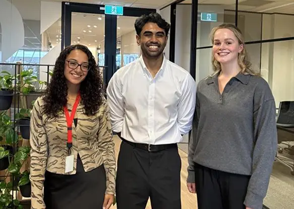 Group of IQ Group graduates collaborating in a professional financial services consulting environment